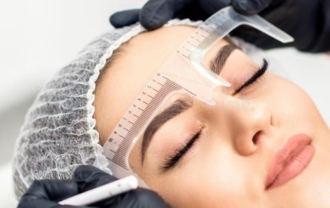 Beautician-measuring-brows-ruler-tattooing-eyebrows-beautician-measuring-brows-ruler-203087641